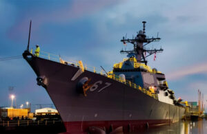 An image of a Navy ship at sunset.