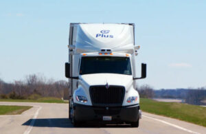 A Plus truck driving on a road.