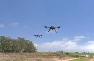 Two Seneca drones flying above grasslands.